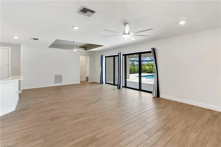 Living room with a ceiling fan and wood tiled floors
