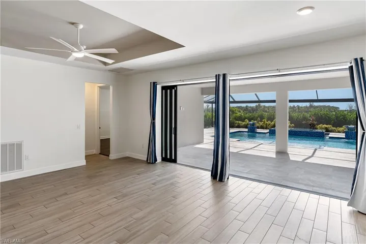 Living room with a ceiling fan and wood tiled floors