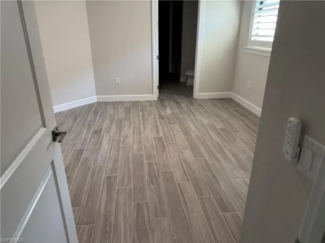 En suite bedroom with wood tiled floors