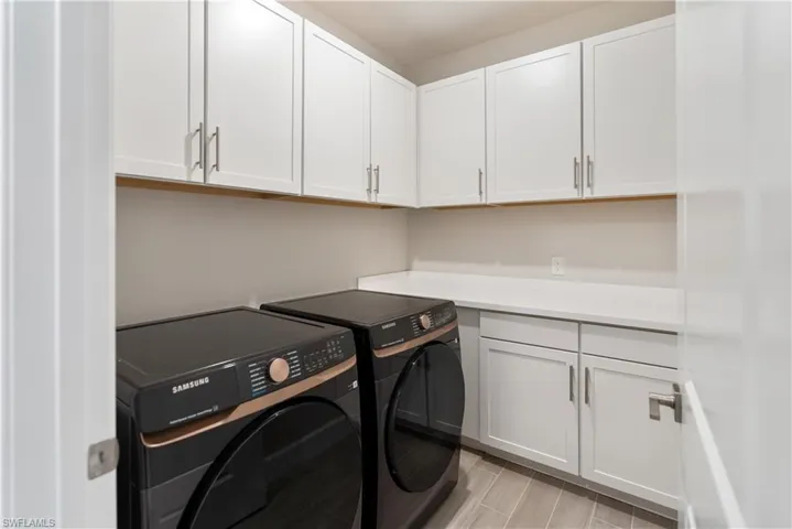 Laundry room featuring washing machine and dryer and cabinet space