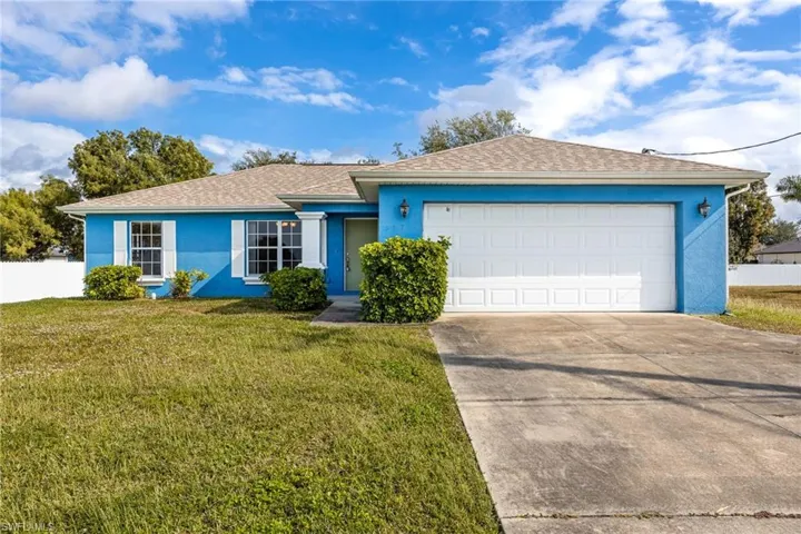 Ranch-style house with stucco siding, driveway, a shingled roof, and an attached garage