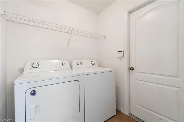 Washroom with washer and clothes dryer