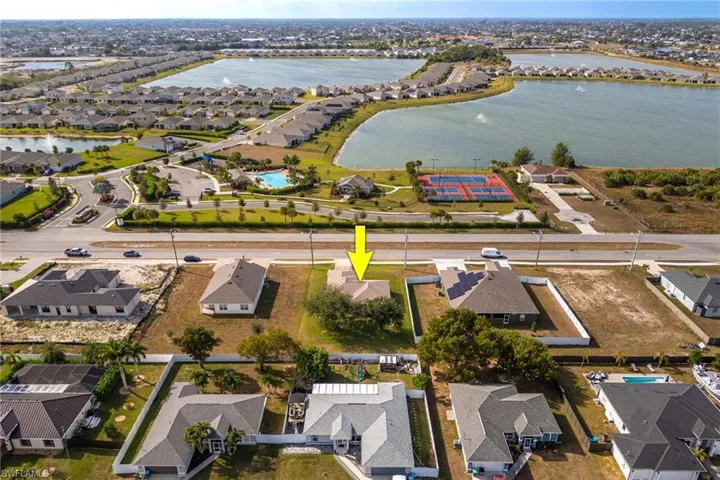 Aerial view of residential area featuring a nearby body of water