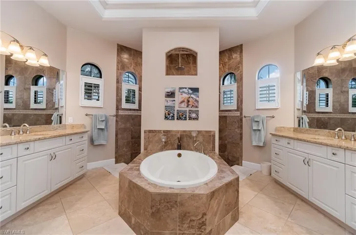 Bathroom with tile walls, vanity, and tile patterned flooring