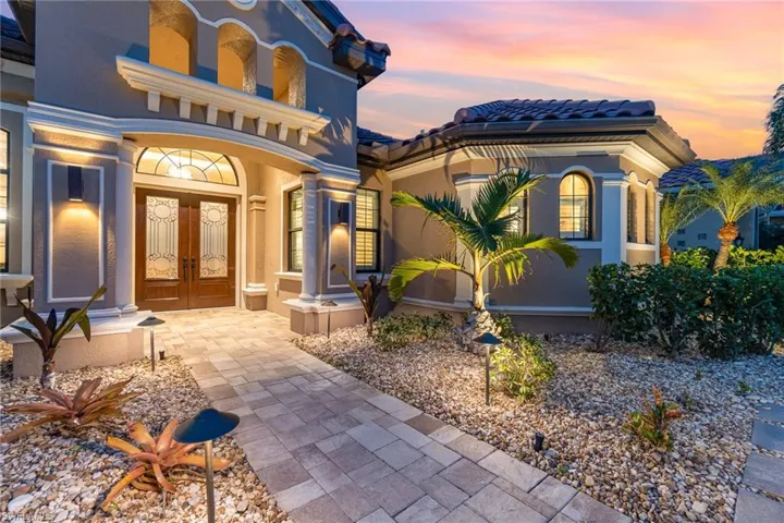 Exterior entry at dusk with french doors