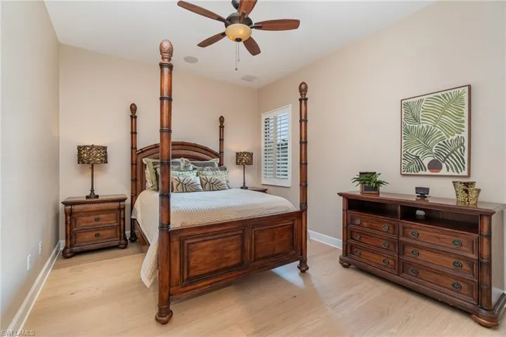 Bedroom featuring ceiling fan and light hardwood / wood-style flooring