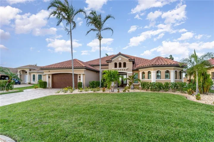 Mediterranean / spanish-style house featuring a garage and a front yard
