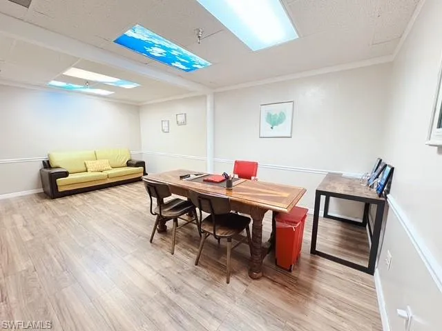 Dining area featuring light wood finished floors and ornamental molding