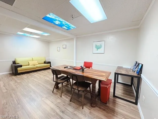 Dining space featuring light wood-style flooring and ornamental molding