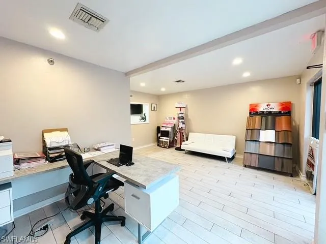 Office with recessed lighting and light wood-style flooring