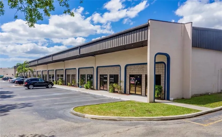 View of building exterior with uncovered parking