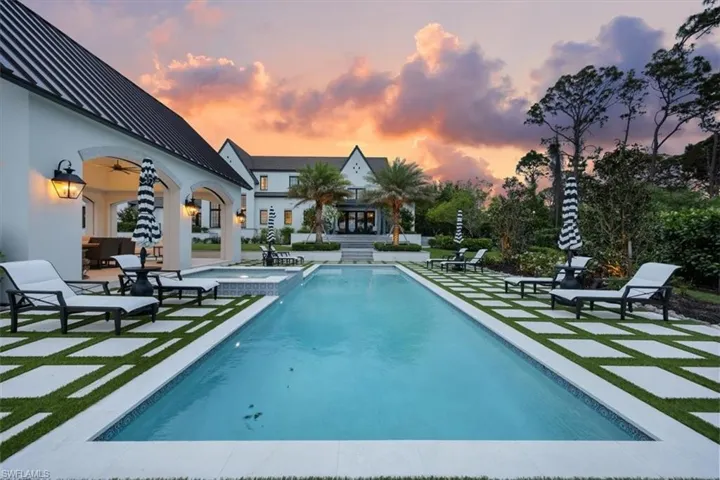 View of pool featuring a patio area, ceiling fan, and a pool with connected hot tub
