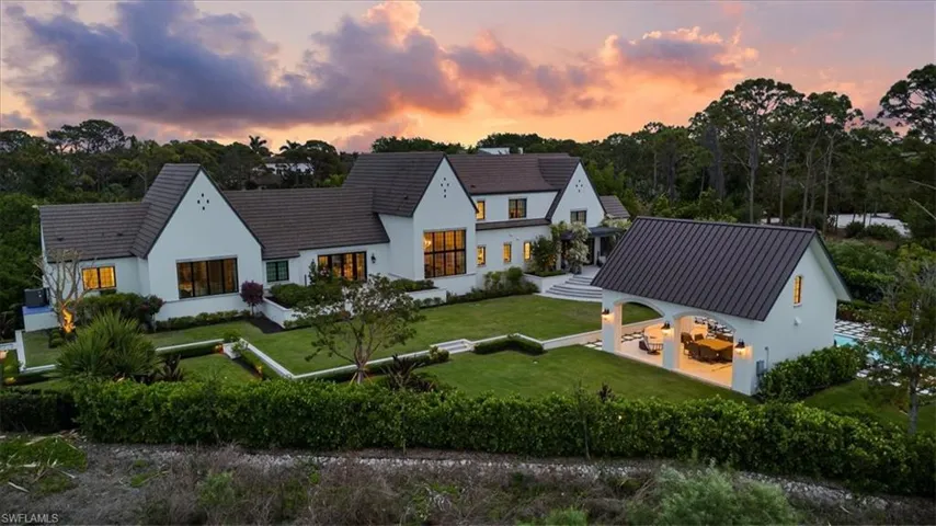 View of front of property with a yard and stucco siding