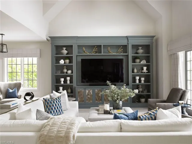 Living room featuring carpet flooring and high vaulted ceiling