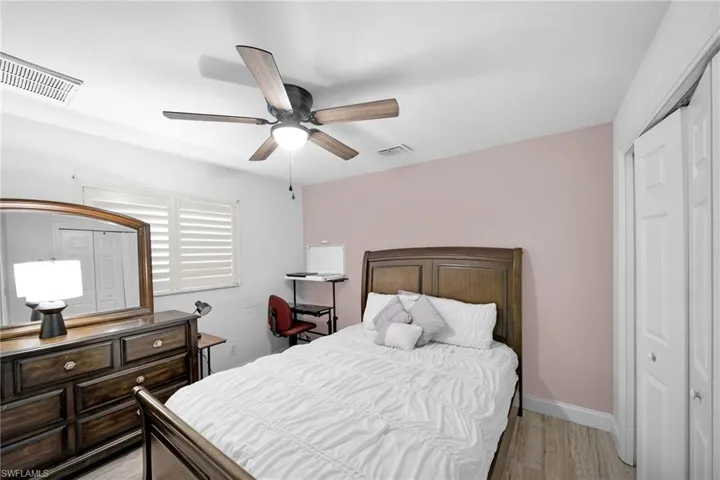 Bedroom featuring a closet, light wood-type flooring, and a ceiling fan
