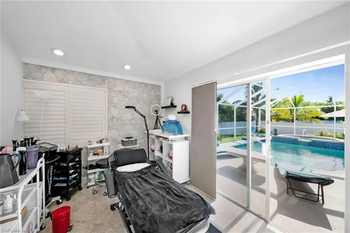 Bedroom featuring light tile patterned floors and access to outside