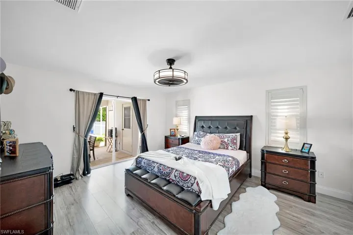 Bedroom with access to exterior and light wood-style flooring