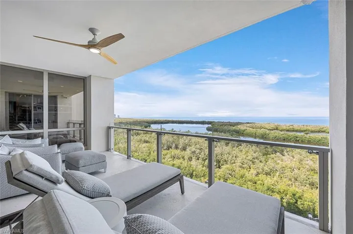 Balcony with ceiling fan and a water view