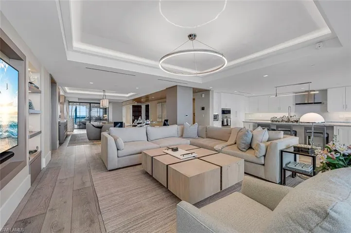 Living room featuring light hardwood / wood-style flooring and a tray ceiling