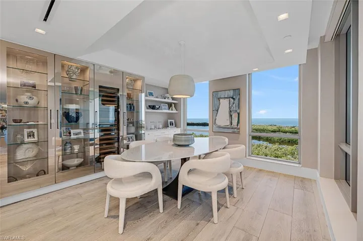 Dining area featuring light hardwood / wood-style flooring and a water view