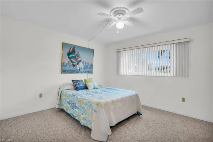 Carpeted bedroom with ceiling fan