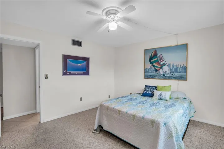 Carpeted bedroom with ceiling fan