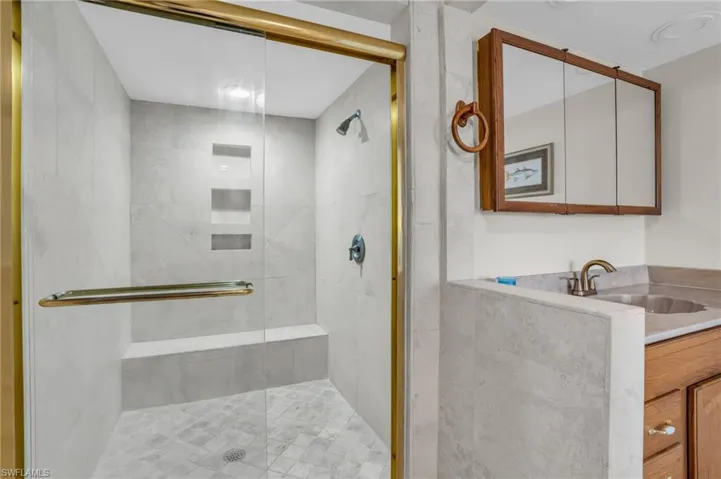 Bathroom with walk in shower and vanity