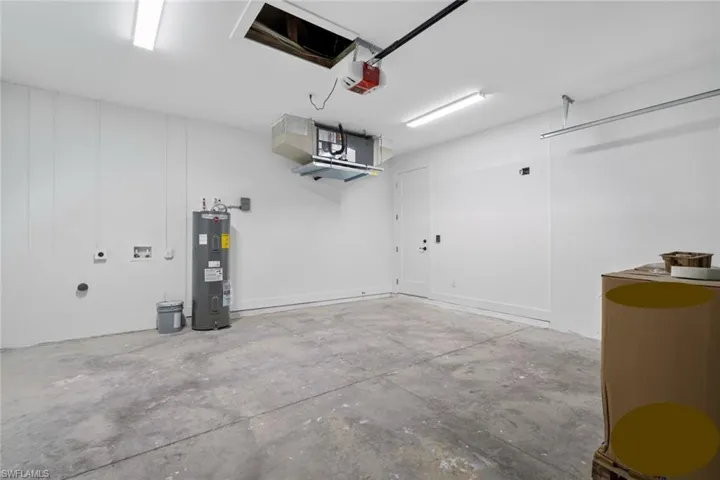 Garage with water heater and a garage door opener