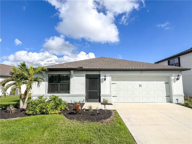 Ranch-style home with a garage, driveway, stucco siding, and roof with shingles