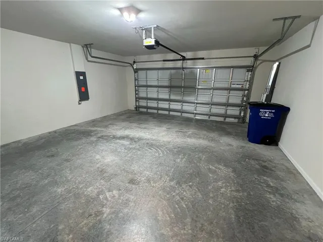 Garage with a garage door opener and electric panel