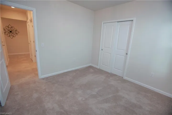 Unfurnished bedroom featuring a closet and carpet floors