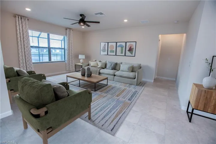 Living area with recessed lighting and ceiling fan
