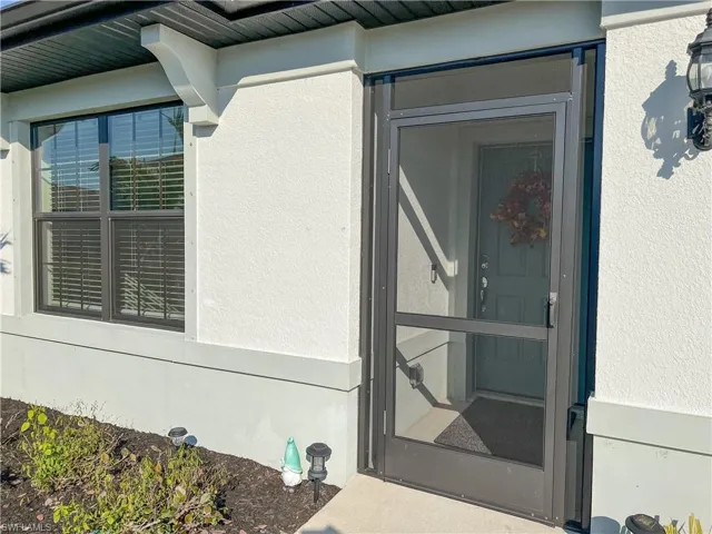 Entrance to property featuring stucco siding