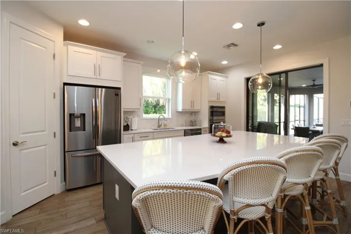 Kitchen featuring white cabinets, dark hardwood / wood-style flooring, stainless steel appliances, and sink