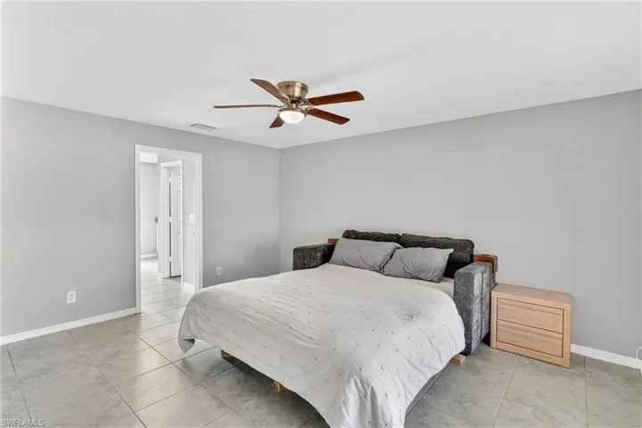 Bedroom featuring ceiling fan and light tile patterned flooring