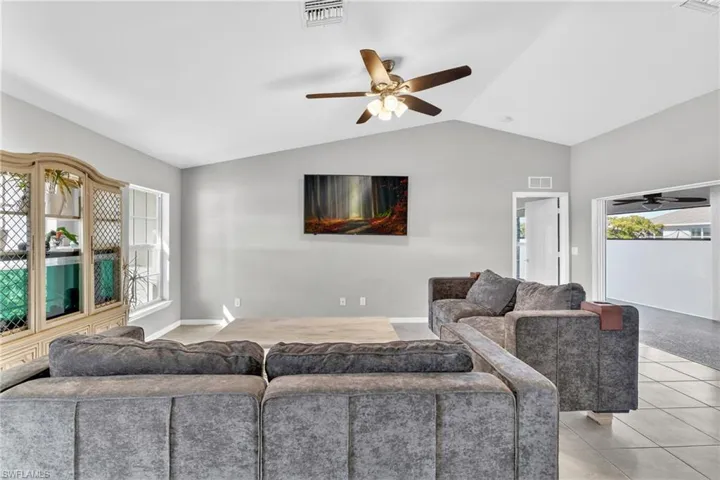 Living room featuring ceiling fan and light tile patterned floors
