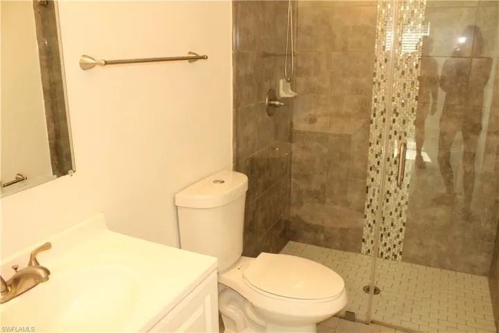 Bathroom with vanity and a shower stall