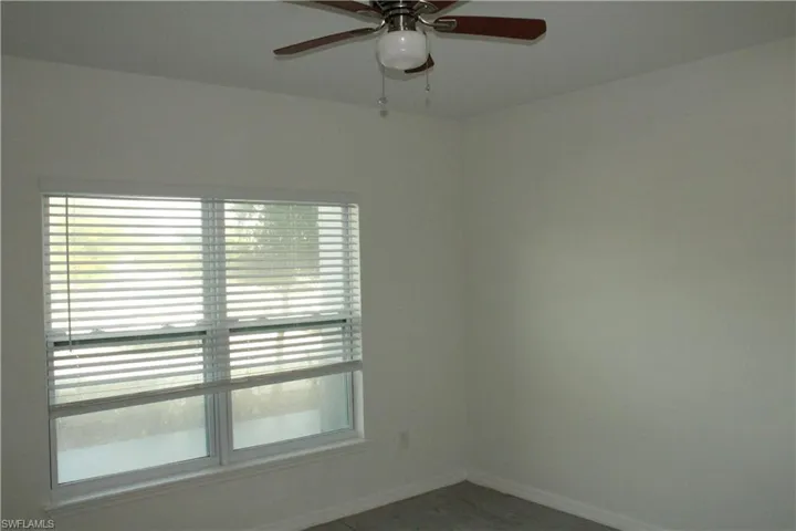 Spare room featuring baseboards and ceiling fan