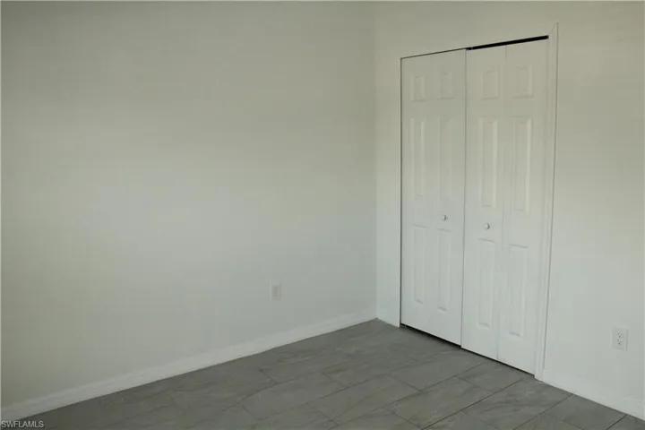 Unfurnished bedroom featuring baseboards and a closet