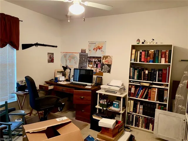 Carpeted office space with ceiling fan