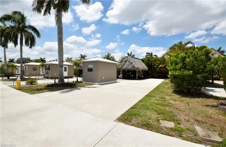 View of front facade featuring a detached carport, concrete driveway, and a gazebo