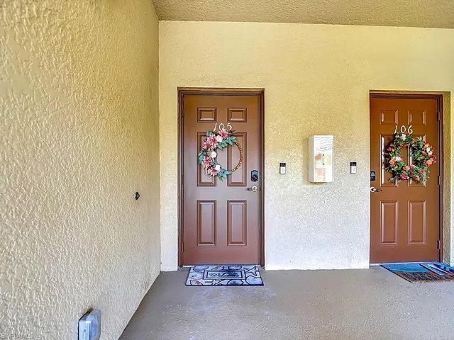 Entryway featuring two paneled doors with contrasting hardware