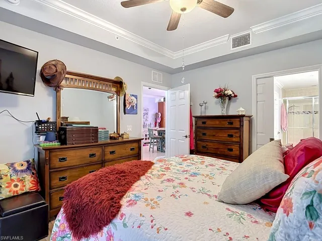 Bedroom featuring crown molding, a ceiling fan, and light gray wall paint