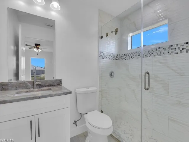 Full bathroom featuring vanity, a stall shower