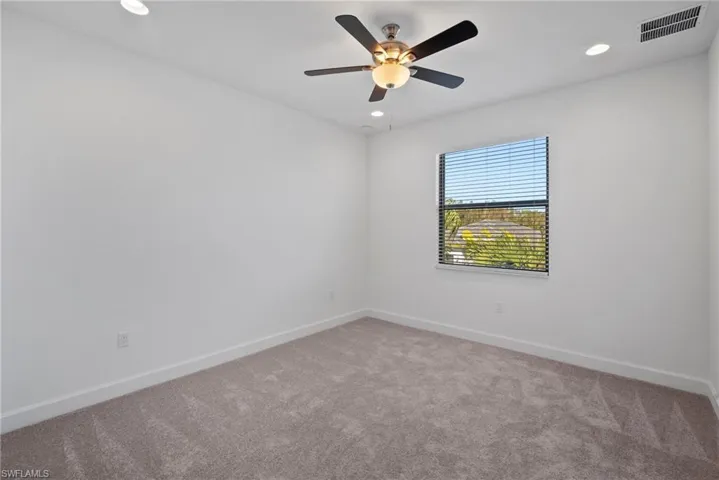 Spare room with light colored carpet, recessed lighting, and a ceiling fan