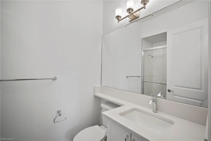 Full bathroom with vanity and a shower stall