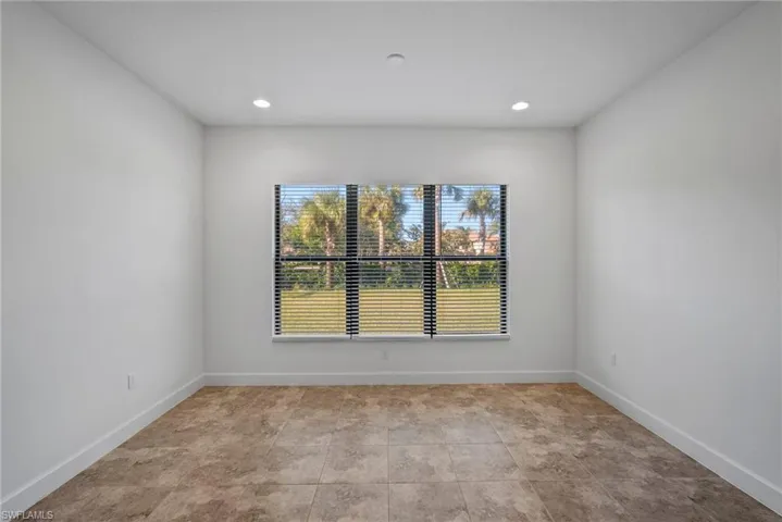 Spare room featuring baseboards and recessed lighting