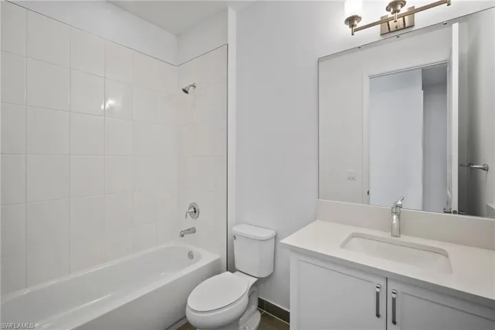 Bathroom featuring vanity and shower / washtub combination
