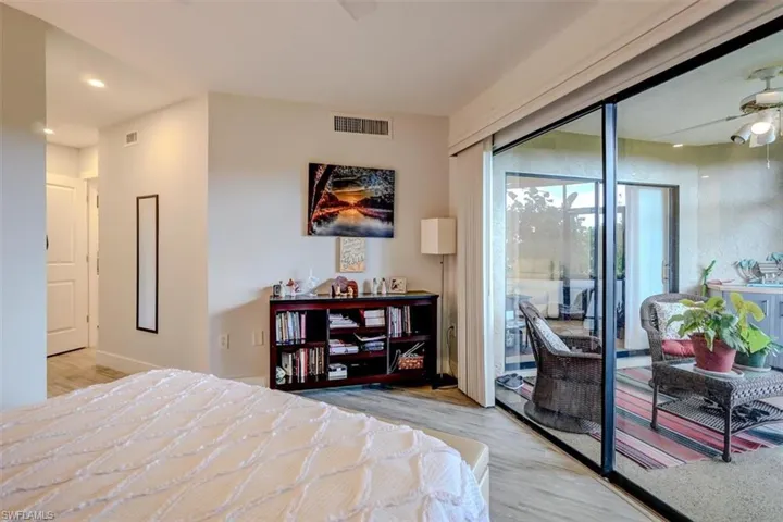 Bedroom with ceiling fan, light hardwood / wood-style floors, and access to outside