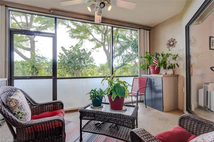 Sunroom / solarium featuring ceiling fan
